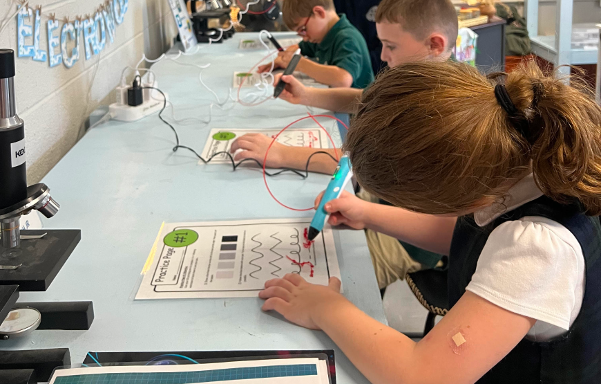 Students using 3D pens in class
